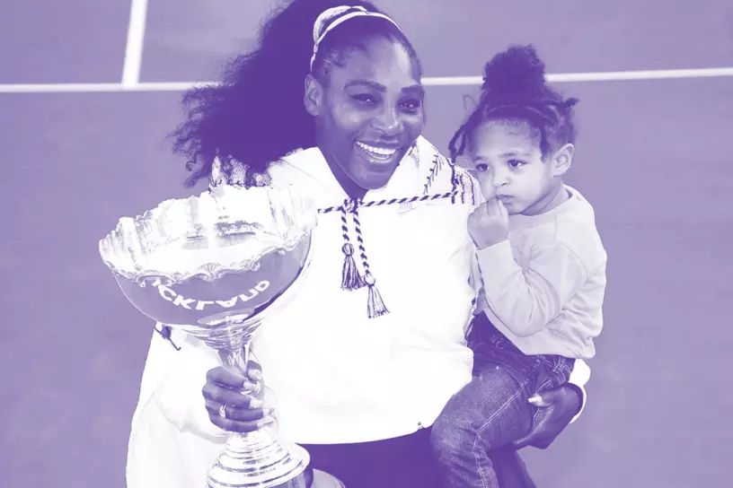 woman holding trophy and child